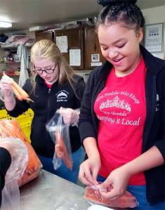 Volunteers at the Central Kitsap Food Bank pack items for holiday meals. Courtesy Photos