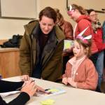 Kate Harwood and Evie Williamson get a book signed by visiting author Dana Simpson.