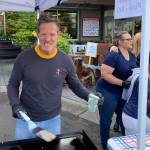 Jeff Rouser cooks to make money for the football program at a fundraiser.