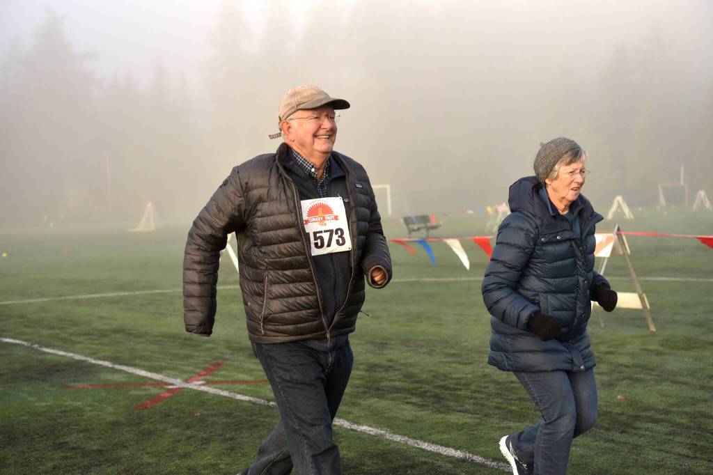 Proctor and Deborah Schenk smile all the way to the finish line to beat their previous record by six seconds.