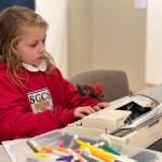 Maddy Owen, 8, a student St. Cecilia Catholic School types a letter to Santa.