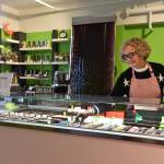 Fiona Ronyai, head of retail operations at LAtelier TR, fills the display case with bonbons and chocolate confections.