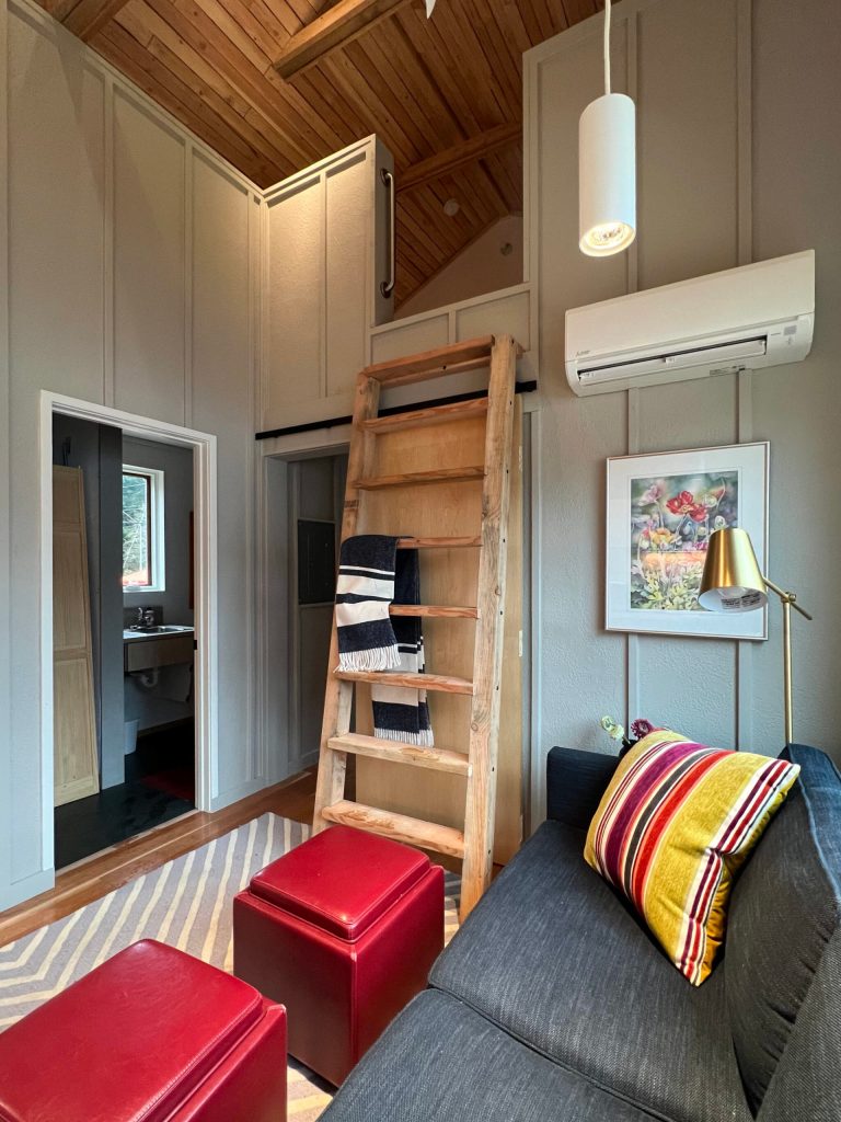 A view of the living room, and bathroom and the loft which is tall enough for a six-foot person to stand up in.