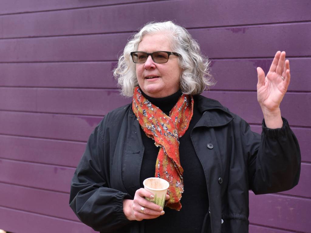 Heather Berger, executive director for Friends of the Farms, speaks with visitors during the Tiny Homes open house Dec. 10 at the Morales Farm.