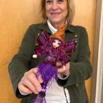 Danna Watson with one of her mermaid dolls.