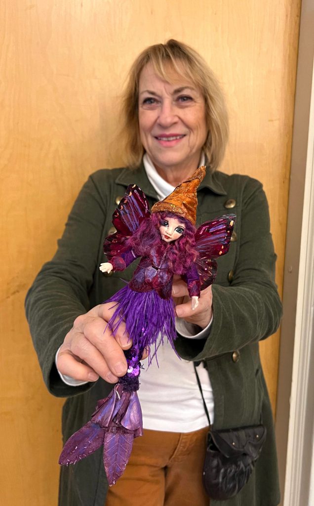 Danna Watson with one of her mermaid dolls.
