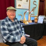 Howard Julien sits in one of his steamed bentwood chairs at the Grange Hall.