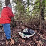 John Dembowski takes a closer look at a sleeping spot in a park in Poulsbo.