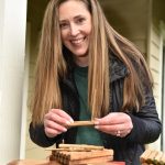 Thyra McKelvie dismantles an old bee house that was full of earwigs and wasps, which are bee predators.