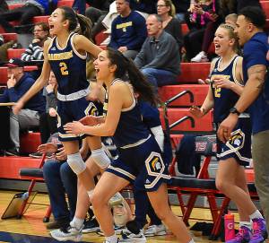 The Spartans stormed the court after winning its first playoff game in four years. Nicholas Zeller-Singh/Kitsap News Group Photos