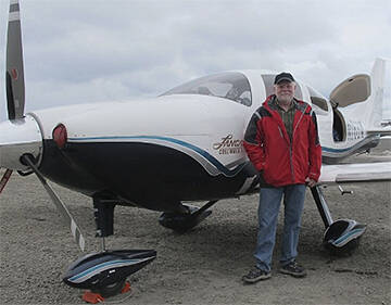 Harry Anderson and the plane he used twice to fly around the world solo.