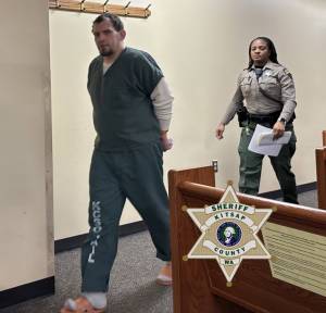 Shaun Rose walks handcuffed through the courtroom accompanied by law enforcement. Kitsap County Sheriffs Office courtesy photo