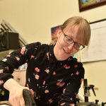Crista Dougherty works on a frame at Julie's Frame Gallery.