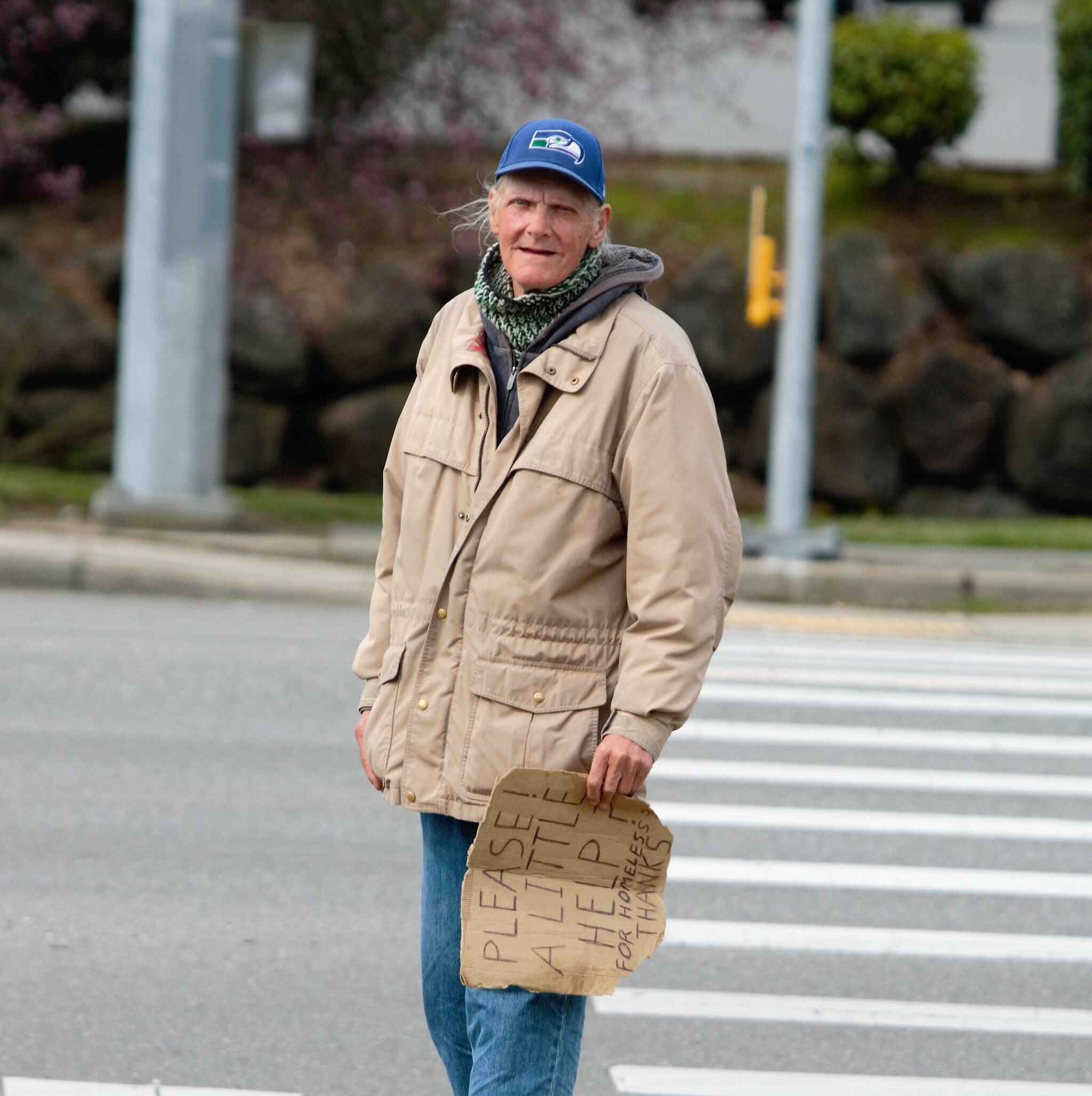 A man stands on the curb nearby Bremertons Fred Meyer asking for cash from passing cars. Elisha Meyer/Kitsap News Group