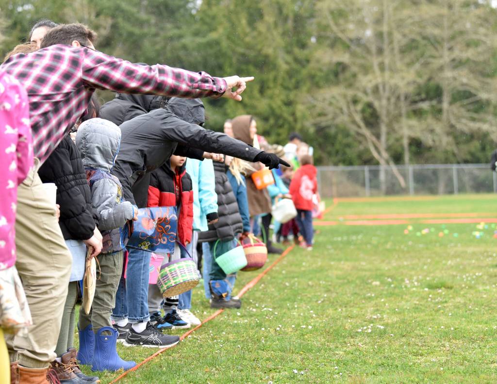 Parents give last-minute advice to their children before they take to the field to gather eggs.