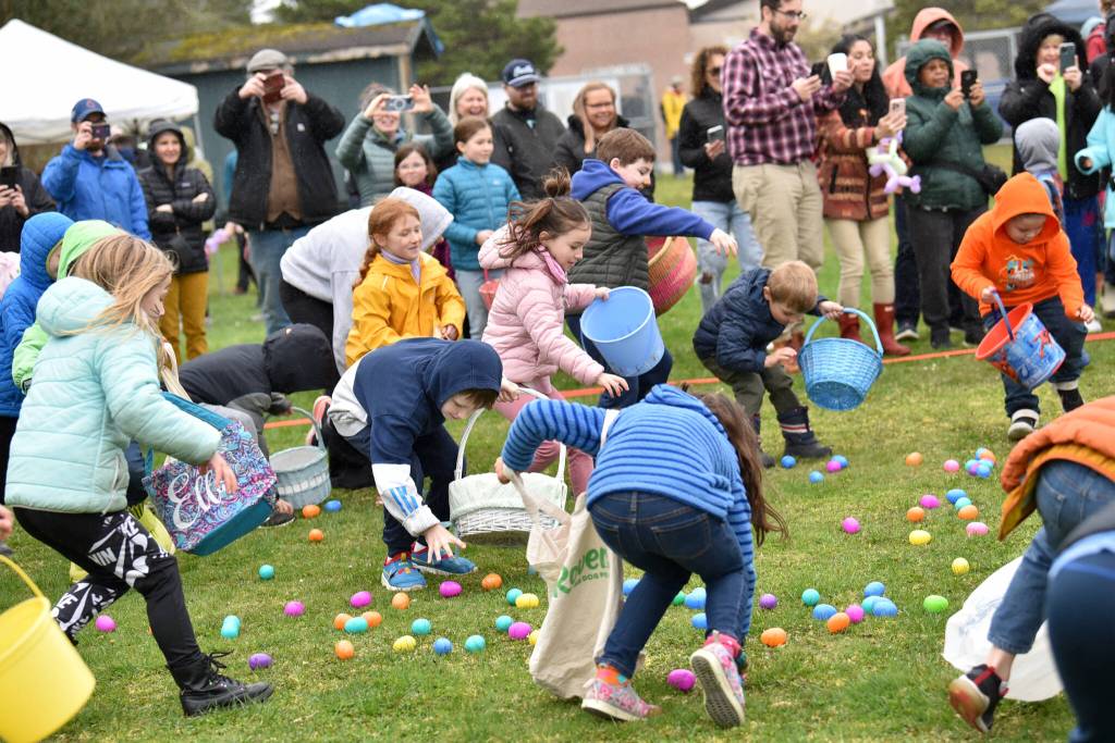 Kids wildly scramble for eggs during the Easter Egg Dash at Woodland Middle School April 8.