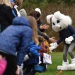 The Easter Bunny runs along the perimeter of the Egg Dash field giving high-fives before the dashing begins.