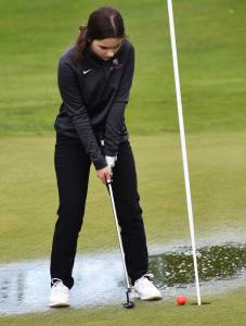 North Kitsaps Calia Corden putts through a puddle to finished the second hole. Nicholas Zeller-Singh/Kitsap News Group Photos