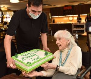Jean Wohlsen receives a cake on her 107th birthday, April 17, at her residence in the Madison House in Bainbridge Island. Nancy Treder/Kitsap News Group Photos