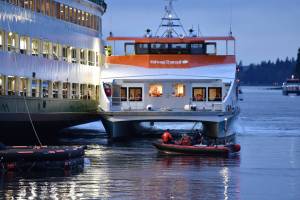 A Kitsap foot ferry parked alongside the Walla Walla to load passengers and take them to Bremerton. Nancy Treder/Kitsap News Group Photos
