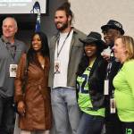 Norm Johnson, Colby Parkinson and Randall Morris take photos with local fans before the Seahawks make a pick.