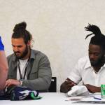 Colby Parkinson and Darrell Taylor sign autographs after practicing for the Seahawks earlier in the day.