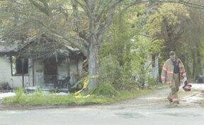 A South Kitsap Fire and Rescue firefighter walks away from a house on Sidney Avenue where Linda Malcom was found dead. File photo