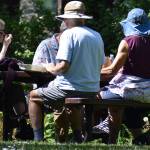 A small group gathers for a discussion at a picnic table in the morning before it got too hot.