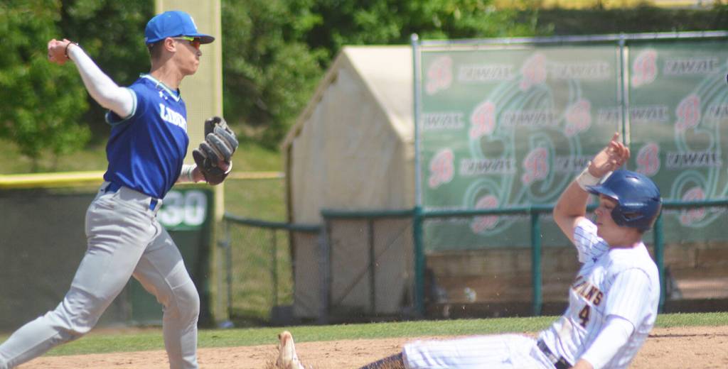 Luke Lavigne slides hard into second base, but Liberty still pulled off a double play.