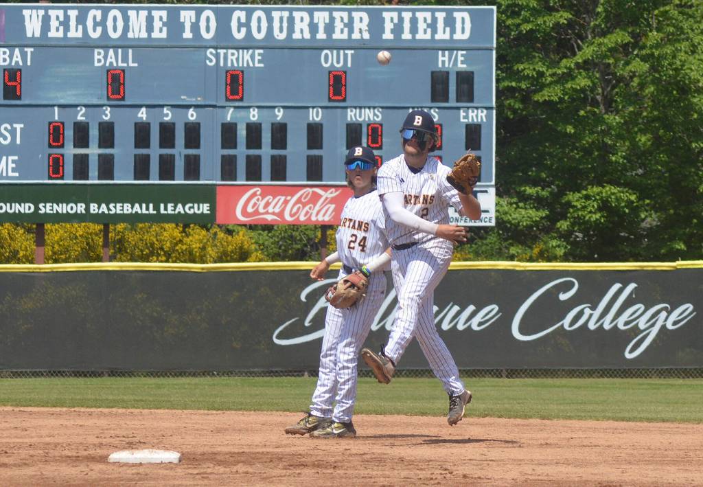 Eddie Bignold, with shortstop McCrea Curfman behind him, makes a tough play up the middle but Liberty ended up with an infield single.