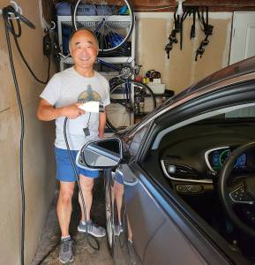 Clarence Moriwaki courtesy photos
Clarence Moriwaki with his mostly electric car, and bicycle in background.