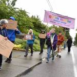 Activists carry a banner in support of queer elders.