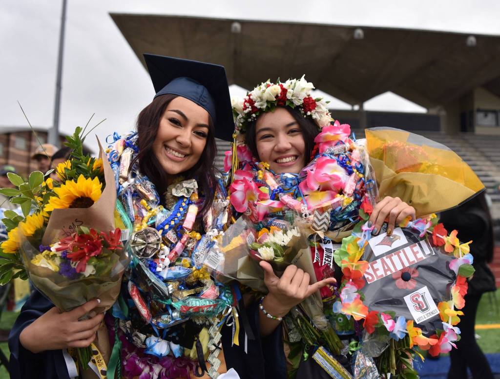BHS graduates Sirenna Salazar and Jenia Viles show off the leis bestowed upon them by friends and family. Salazar is going to take a gap year and Viles will be going to Seattle University in the fall.
