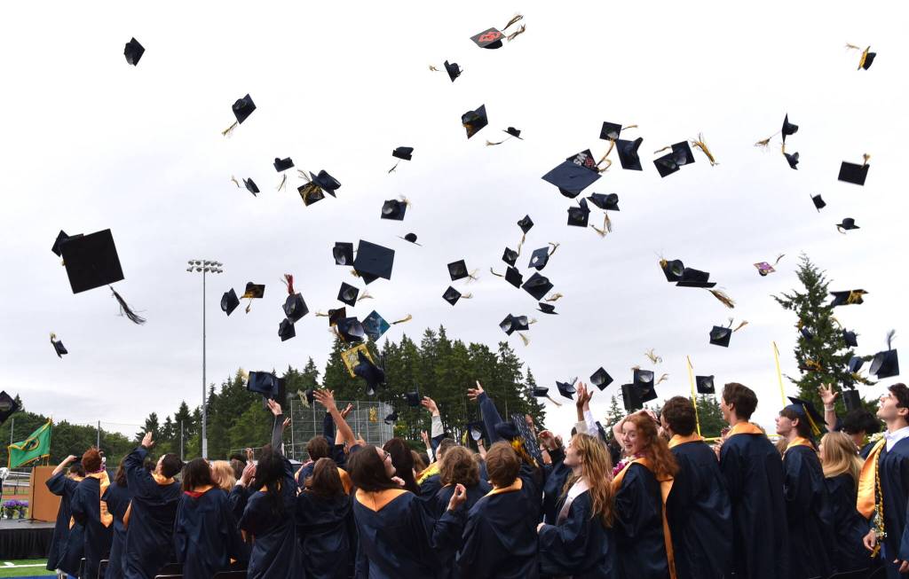 Caps fly into the air after the presentation of the diplomas.