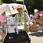 A volunteer from the Green Team moves items to the LOO.