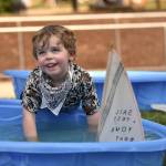 Hans Huntsman, 3, plays with wooden boats in the Kids Zone.