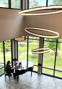A pianist plays for visitors touring the new apartments at Fieldstone Rolling Bay Bainbridge on Manitou Park Boulevard NE. Nancy Treder/Kitsap News Group Photos