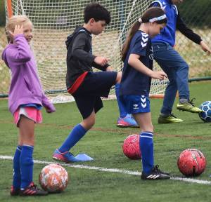 Sydney Leech and Taylor Keaty-Wallorich practice dribbling with Everton coaches. Nicholas Zeller-Singh/Kitsap News Group Photos