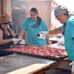 Cooks prepare salmon for the evening feast.