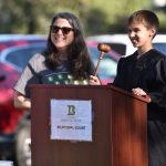 A child bangs the gavel to deliver justice at the Bainbridge Court activity.