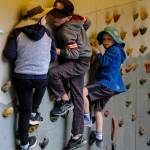 Youngsters hang out on a climbing wall.