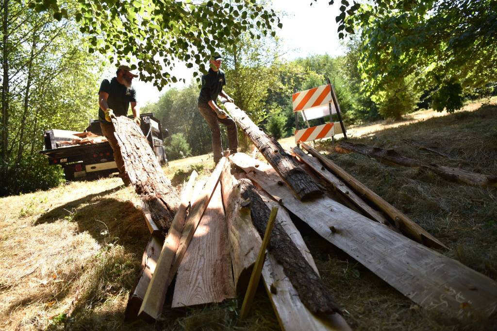 Parks department personnel load up excess building materials at Sakai Park.
