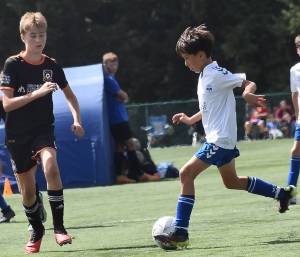 Nicholas Zeller-Singh/Kitsap News Group Photos
The Island Cup, which brings 89 soccer teams of all ages to Bainbridge Island, is taking place this weekend at Battle Point Park, Woodward Middle and Bainbridge High. BI Football Club is one of the teams. Here, Brady Treve dribbles into the opponents defense.