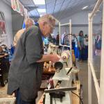 Passersby can check out a live demonstration at the Olympic Peninsula Woodturners table.