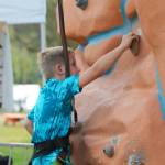 This boy comes up short of winning $100 at the top of the rock climb.