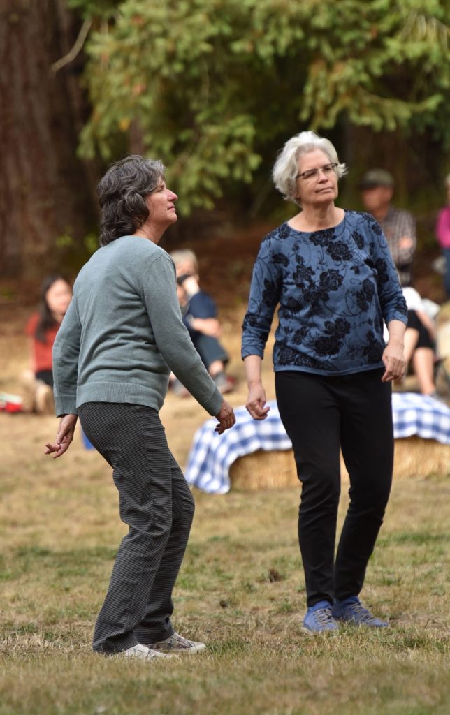 Sisters Johanna Munson and Corey Munson dance to the tunes of the WHOZYAMAMA band.
