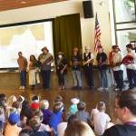 Suquamish tribal members share their culture and traditions with x̌alilc Elementary School students Sept. 8.