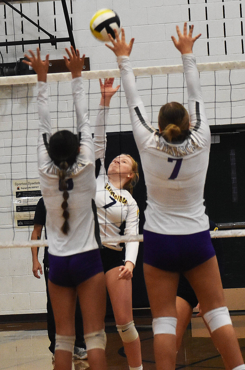 Bainbridges Rollins Anderson smashes the ball past two Vikings.
