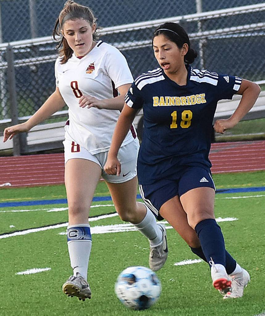 Maya Fletcher dribbles past Kingston defenders.