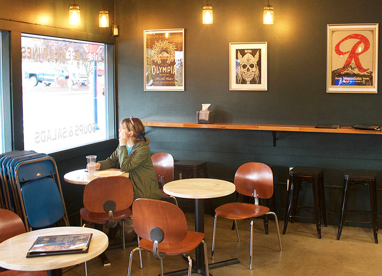 A customer enjoys their meal at the new Premier Meat Pies location in Poulsbo.
